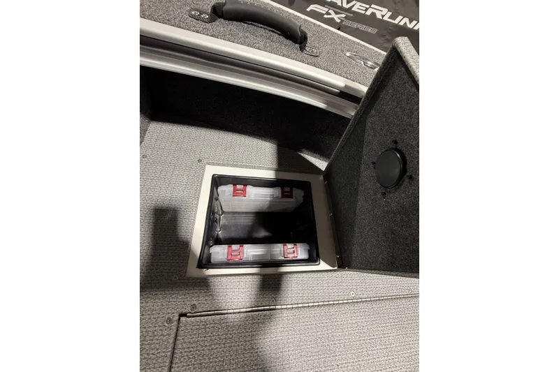 Slide: The Image of 2025 G3 Angler V1850 SF boat storage compartment with organized tackle boxes. - 9