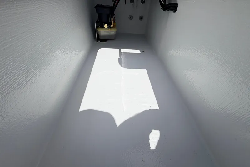 Slide: The Image of Interior view of a 2025 Hell's Bay Professional boat compartment with equipment. - 57