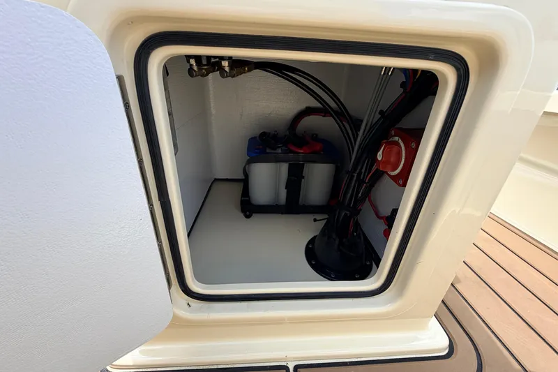 Slide: The Image of Open compartment of 2025 Hell's Bay Professional boat showing battery and wiring. - 51