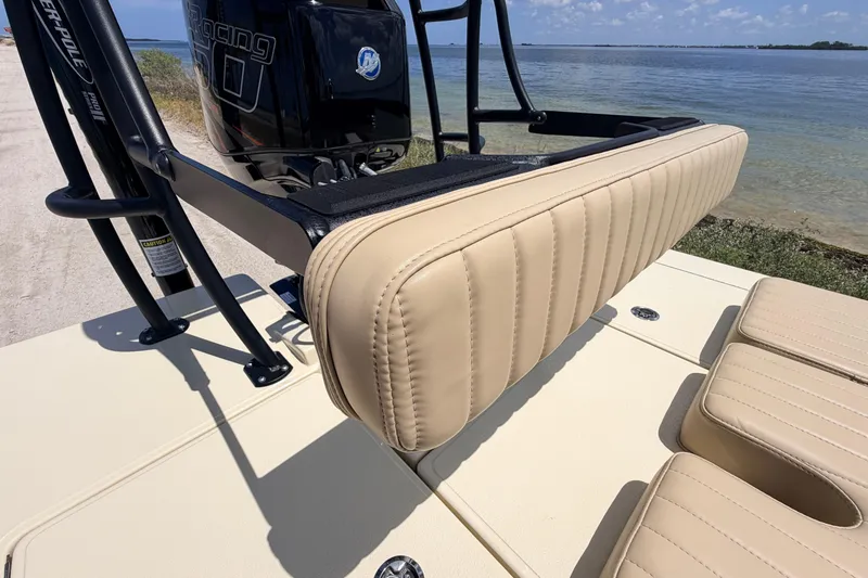 Slide: The Image of 2025 Hell's Bay Professional boat with beige seating, near a serene waterfront. - 67