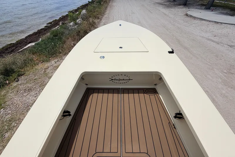 Slide: The Image of 2025 Hell's Bay Professional boat on a sandy shore, showcasing sleek design and craftsmanship. - 30