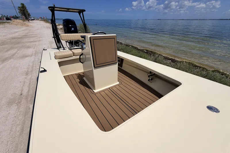 Slide: The Image of 2025 Hell's Bay Professional boat with sleek design, docked by a scenic shoreline. - 37