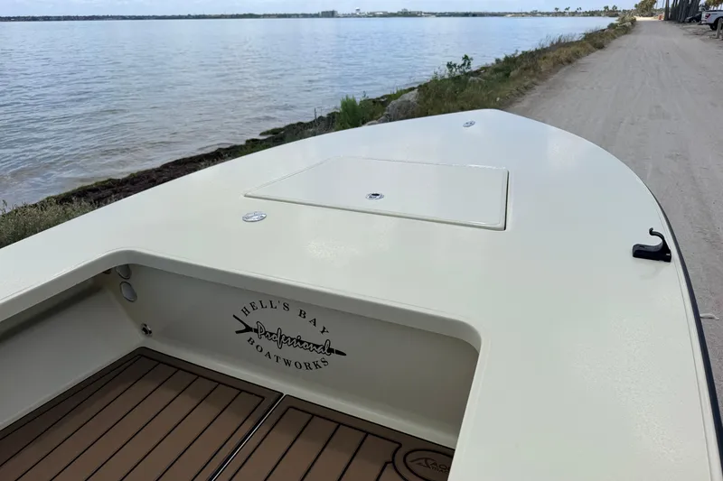 Slide: The Image of 2025 Hell's Bay Professional boat on sandy shore by calm waters. - 29