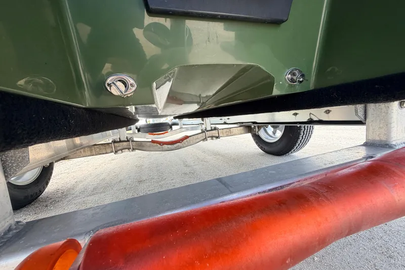 Slide: The Image of Underneath view of a 2025 Hell's Bay Professional boat on a trailer. - 19