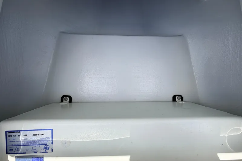 Slide: The Image of Interior view of a 2025 Hell's Bay Professional boat compartment, showcasing storage space. - 36