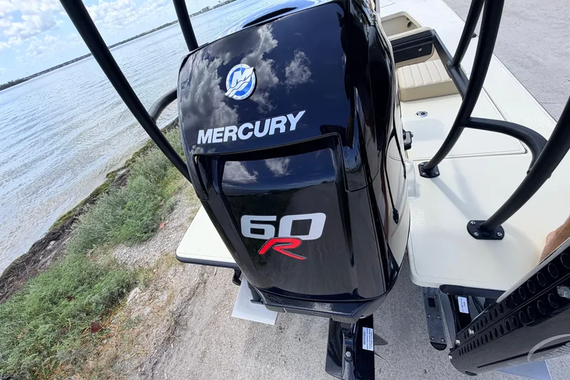 Slide: The Image of 2025 Hell's Bay Professional boat with Mercury 60R engine by the water. - 71