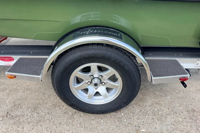 Slide: The Image of 2025 Hell's Bay Professional trailer wheel with Loadstar tire and stainless steel accents. - 14