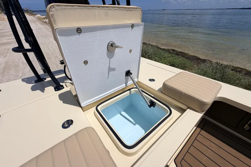 Slide: The Image of Open storage compartment on 2025 Hell's Bay Professional boat by the water. - 60