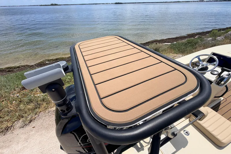 Slide: The Image of 2025 Hell's Bay Professional boat with tan deck, steering wheel, and water view. - 69