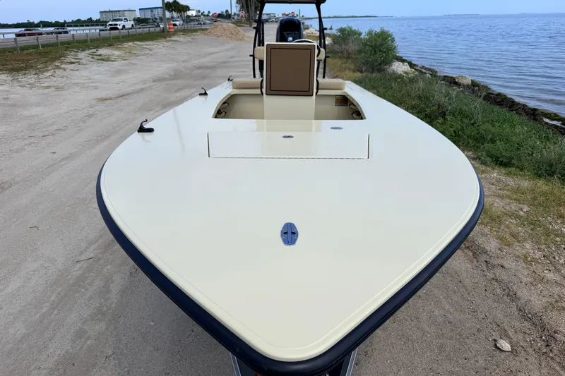Slide: The Image of 2025 Hell's Bay Professional boat on a sandy shore near the water. - 28