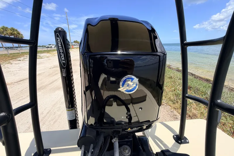 Slide: The Image of 2025 Hell's Bay Professional boat engine by the shore, featuring Power-Pole accessory. - 66