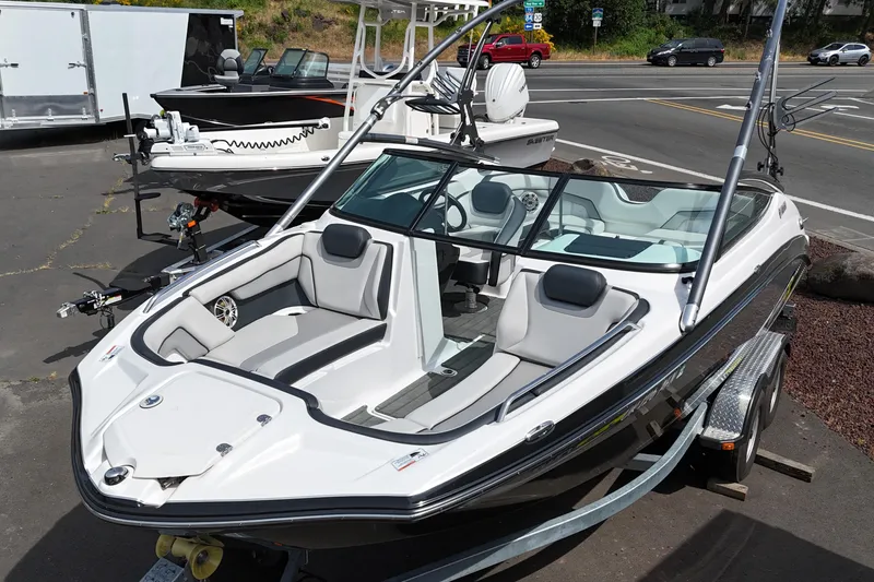 Slide: The Image of 2016 Yamaha Boats 212X on trailer, sleek design, parked outdoors. - 5