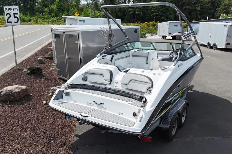 Slide: The Image of 2016 Yamaha Boats 212X on trailer, parked near road with speed limit sign. - 12