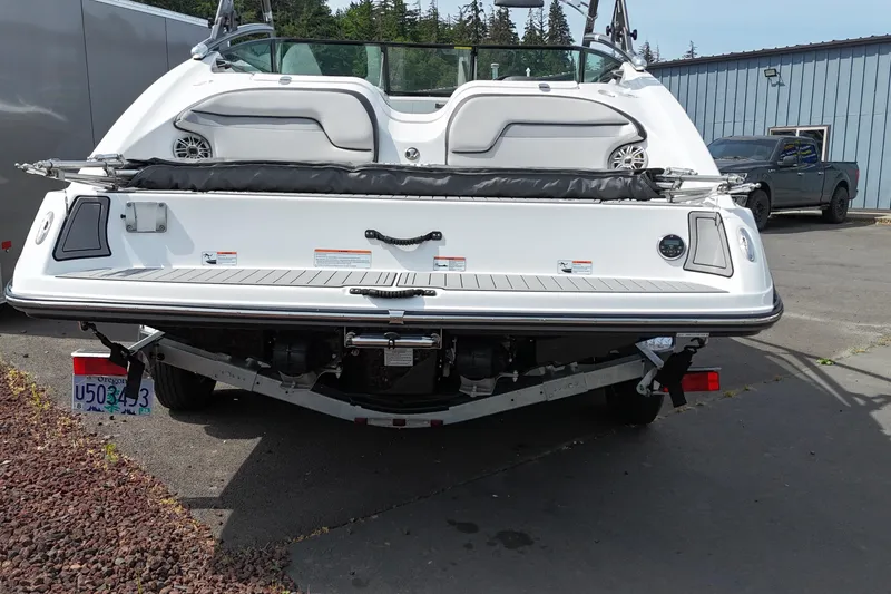 Slide: The Image of Rear view of a 2016 Yamaha Boats 212X on a trailer, parked outdoors. - 11