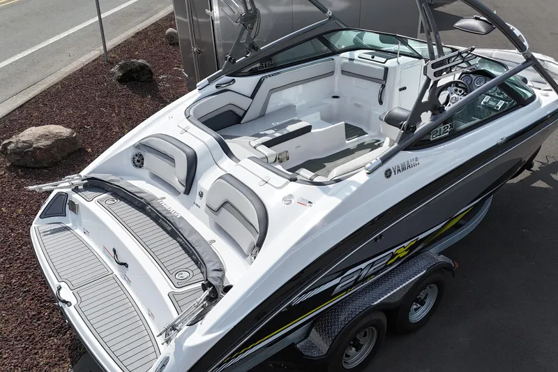 Slide: The Image of 2016 Yamaha Boats 212X, sleek design, spacious interior, parked on trailer, ready for adventure. - 14