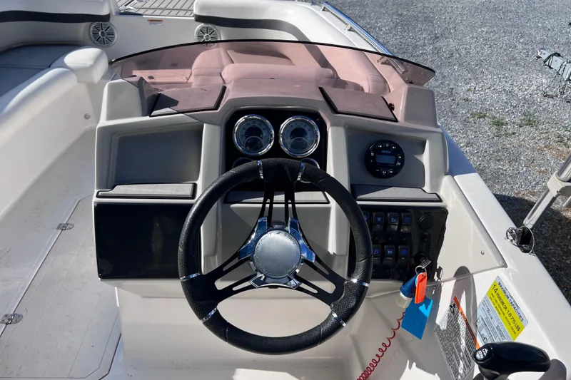 Slide: The Image of 2021 Starcraft SVX 211 OB boat dashboard with steering wheel and control panel. - 6