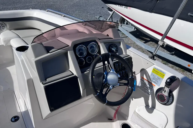 Slide: The Image of 2021 Starcraft SVX 211 OB boat dashboard with steering wheel and control panel. - 5