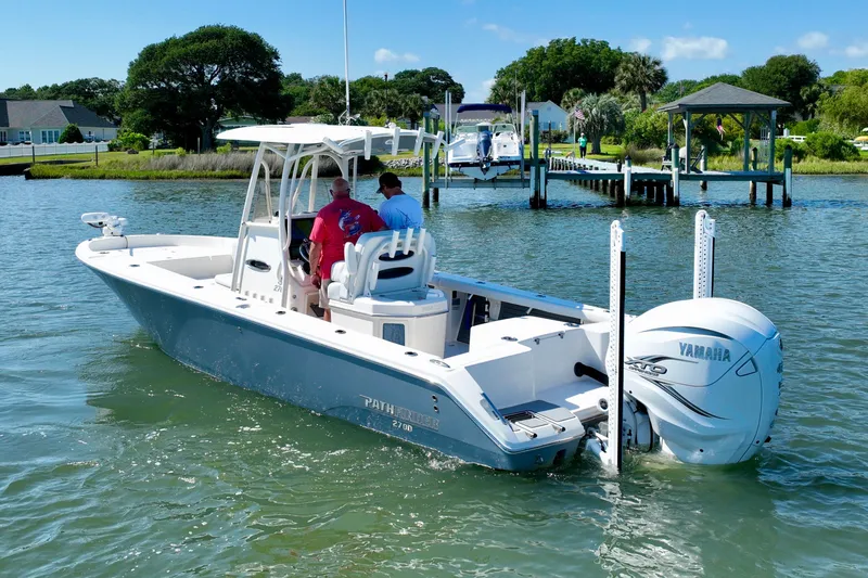 Slide: The Image of A white boat with two people navigates calm waters. It features a Yamaha engine. - 10