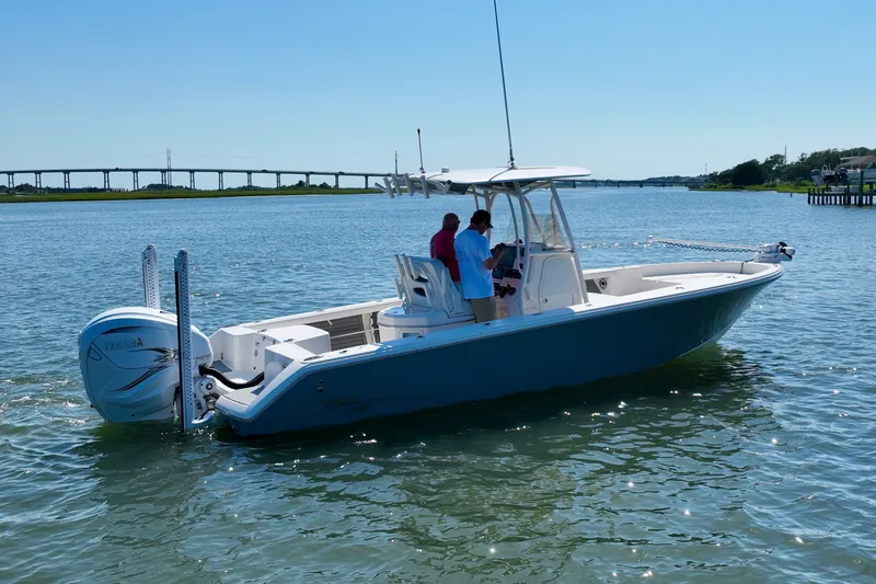 Slide: The Image of A blue boat floating on calm water, with two people on board. - 8