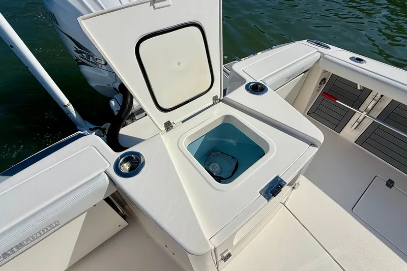 Slide: The Image of The image shows the deck of a 2022 Pathfinder 2700 Open boat with an open storage compartment. - 35