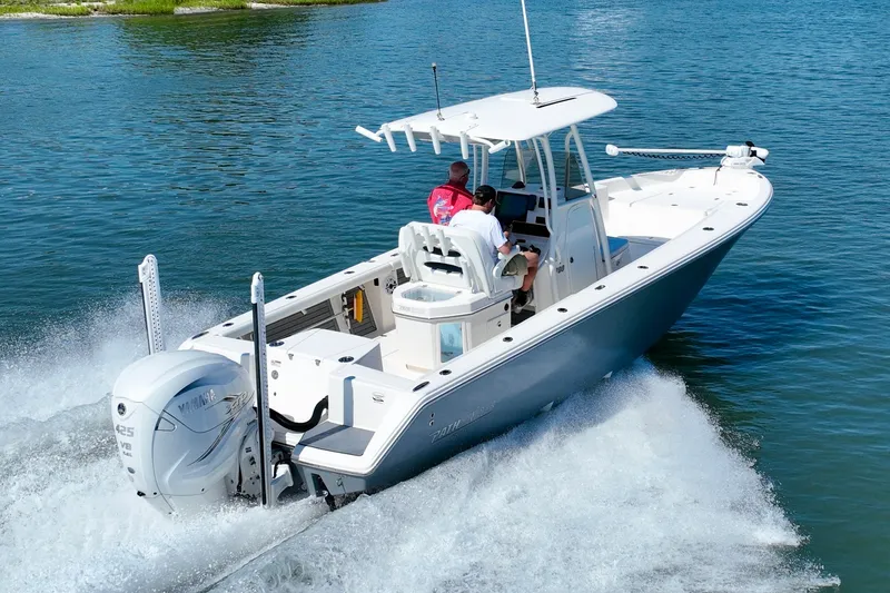 Slide: The Image of A white motorboat speeds across calm water with two people on board. - 14