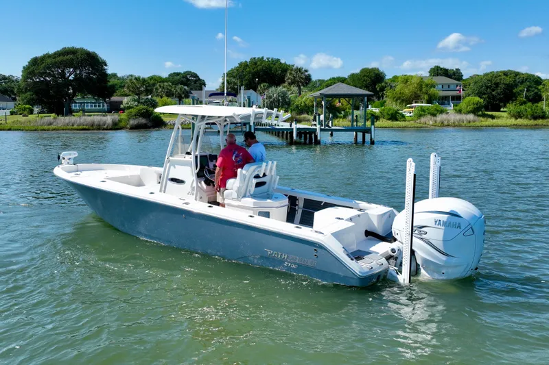 Slide: The Image of Pathfinder 2700 Open 2022 on calm water with two people on board. - 1