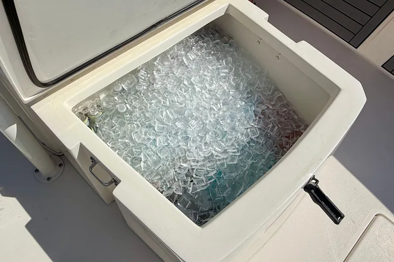 Slide: The Image of An open cooler compartment on a boat, filled with ice cubes. - 28