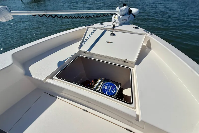 Slide: The Image of An open storage compartment on a boat with a trolling motor at the front. - 24