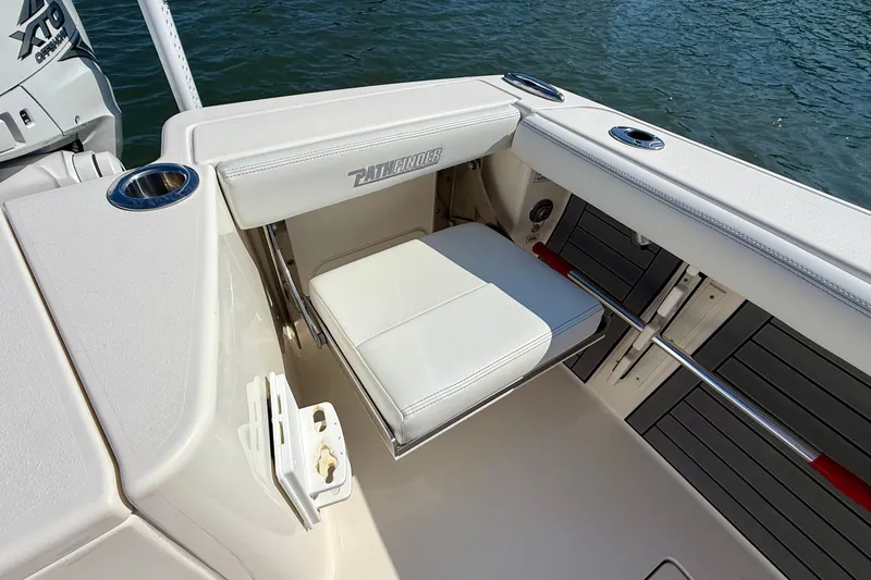 Slide: The Image of A seating area on a 2022 Pathfinder 2700 Open boat, overlooking the water. - 48