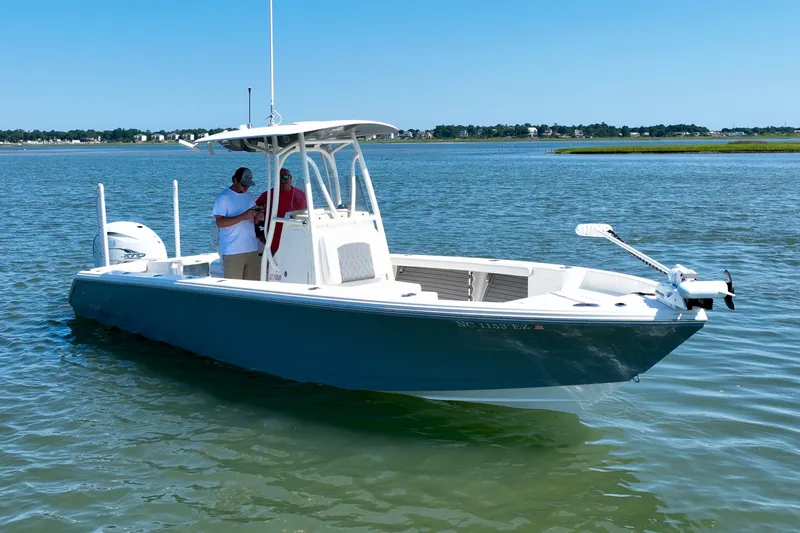 Slide: The Image of Pathfinder 2700 Open 2022 on calm water with two people on board. - 5