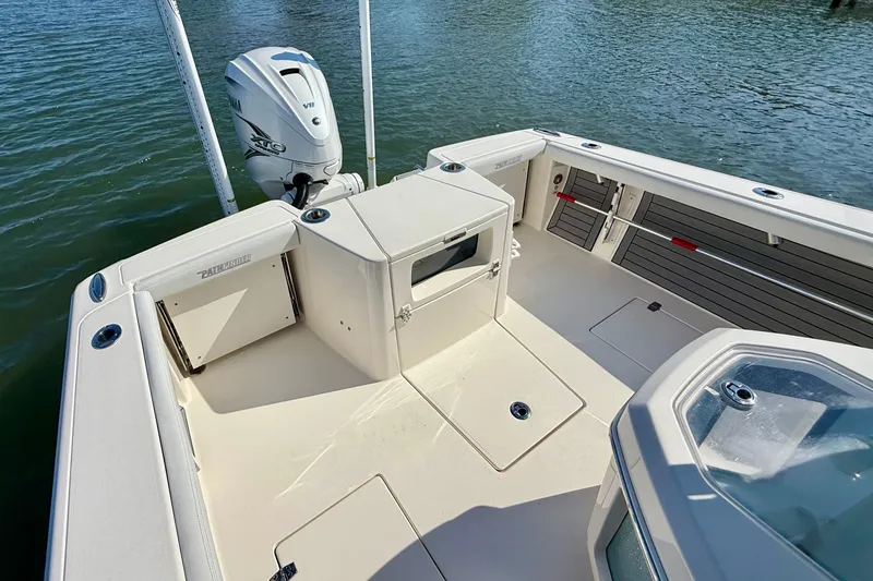Slide: The Image of The image shows the stern of a 2022 Pathfinder 2700 Open boat. It features an outboard motor and spacious deck. - 49