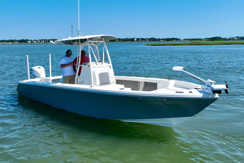 Slide: The Image of A blue boat on calm water with two people on board. - 6