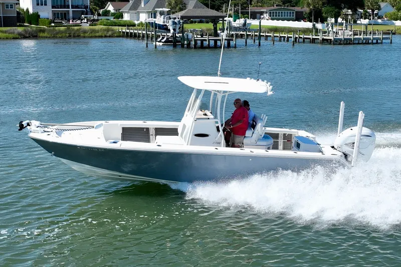 Slide: The Image of A 2022 Pathfinder 2700 Open boat speeding on the water, with two people on board. - 12