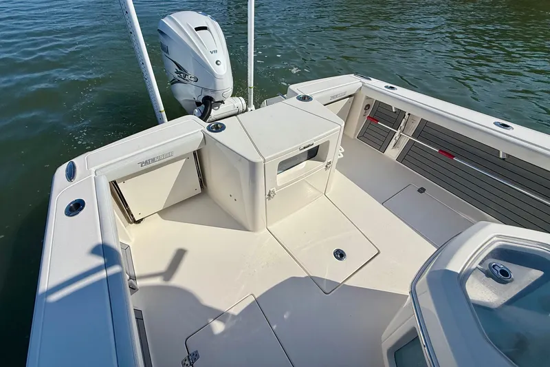 Slide: The Image of The image shows the stern of a 2022 Pathfinder 2700 Open boat on the water. - 34