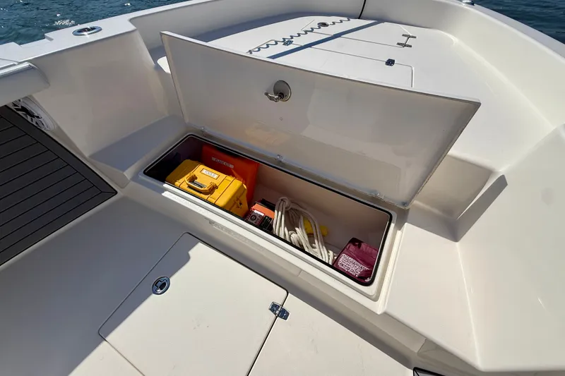 Slide: The Image of An open storage compartment on a boat with life jackets and ropes. - 25
