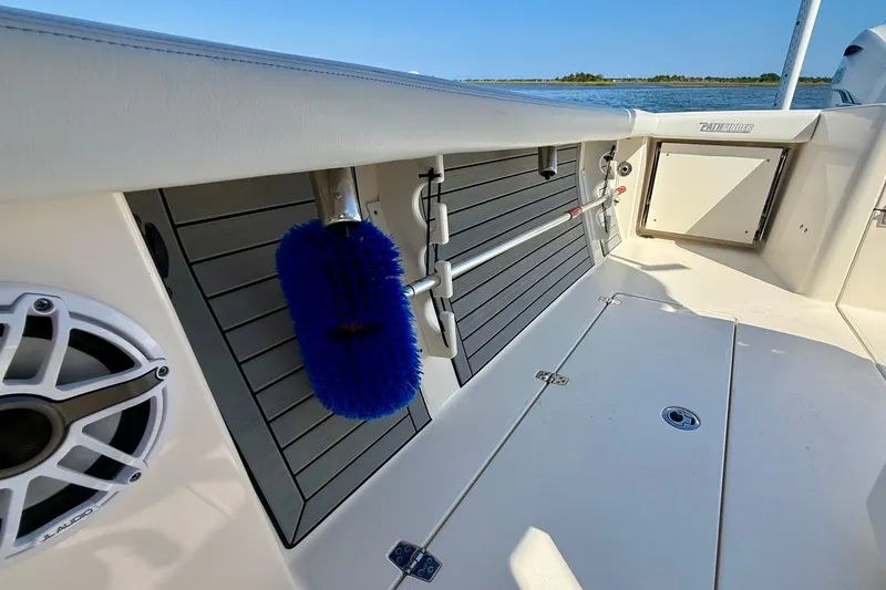 Slide: The Image of The image shows the deck of a 2022 Pathfinder 2700 Open boat with a blue brush head. - 32