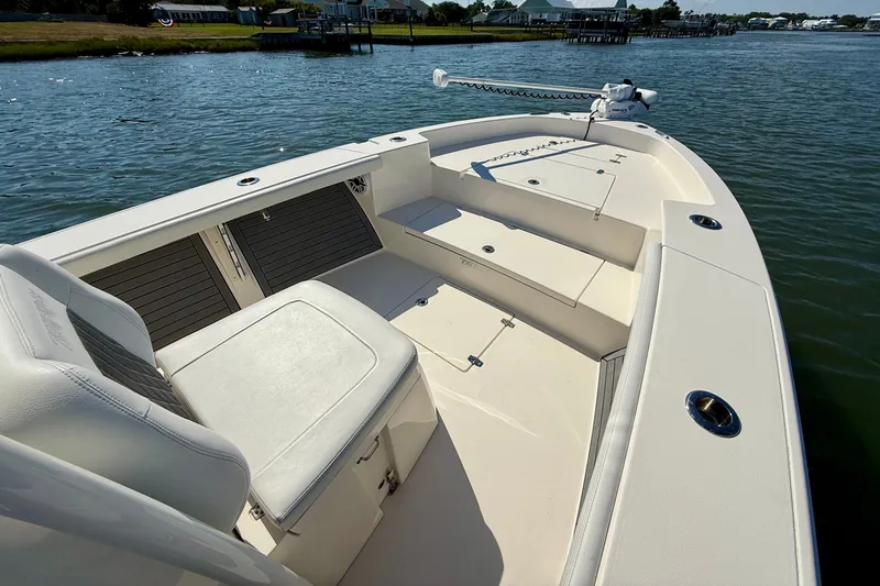 Slide: The Image of A 2022 Pathfinder 2700 Open boat on calm water with seating and storage areas. - 20