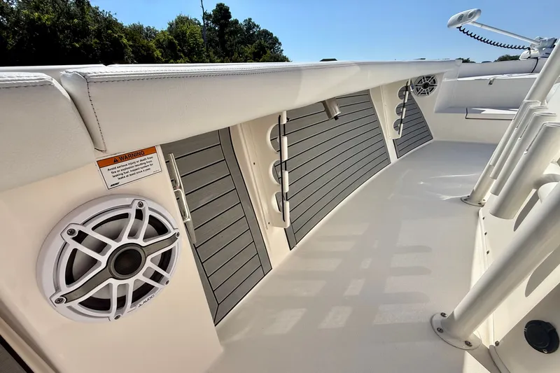 Slide: The Image of The image shows the deck of a 2022 Pathfinder 2700 Open boat with speakers and cushions. - 31