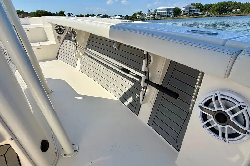 Slide: The Image of The image shows the deck of a 2022 Pathfinder 2700 Open boat with speakers and rod holders. - 30