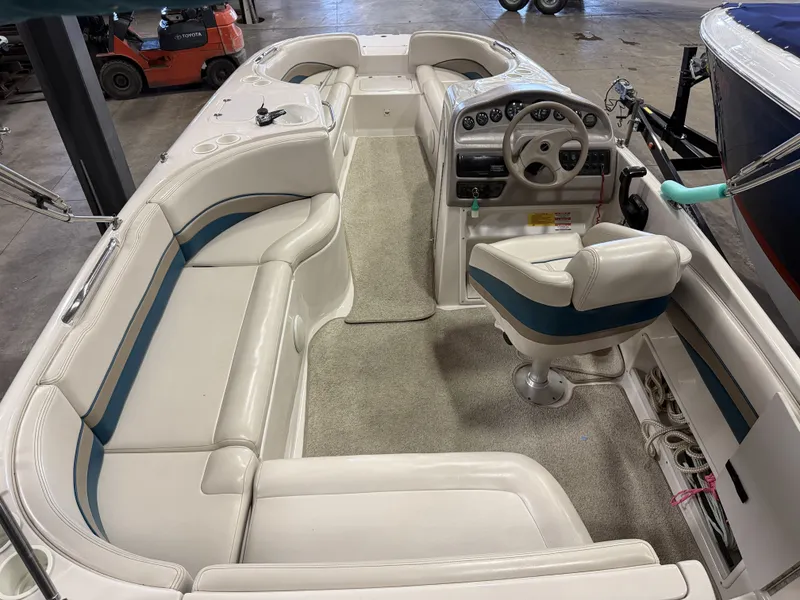 Slide: The Image of Interior view of a 1996 Chaparral 210 Sunesta with white seating and a helm station. - 17
