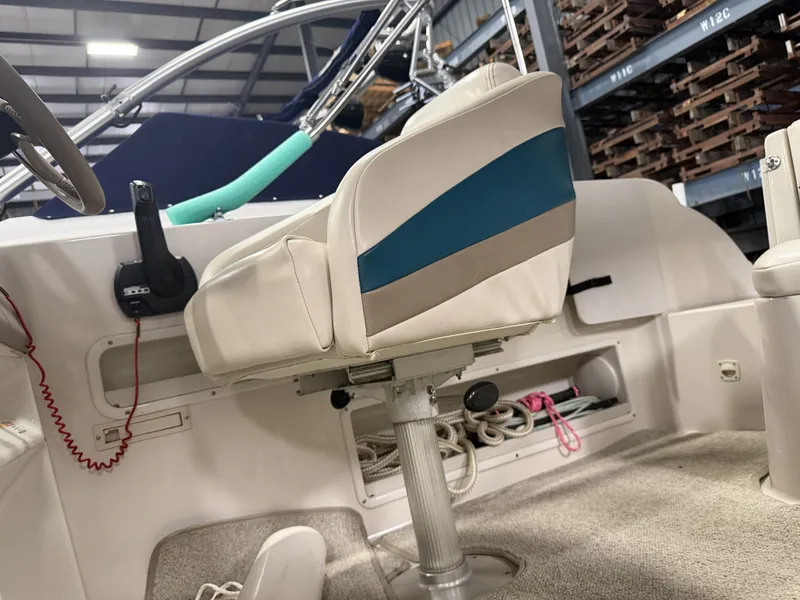 Slide: The Image of Interior view of a 1996 Chaparral 210 Sunesta with a swivel captain's chair and helm console. - 22