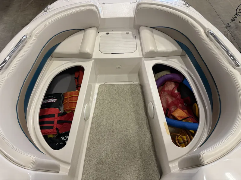 Slide: The Image of The image shows the bow area of a Chaparral 210 Sunesta boat with storage and accessories. - 34