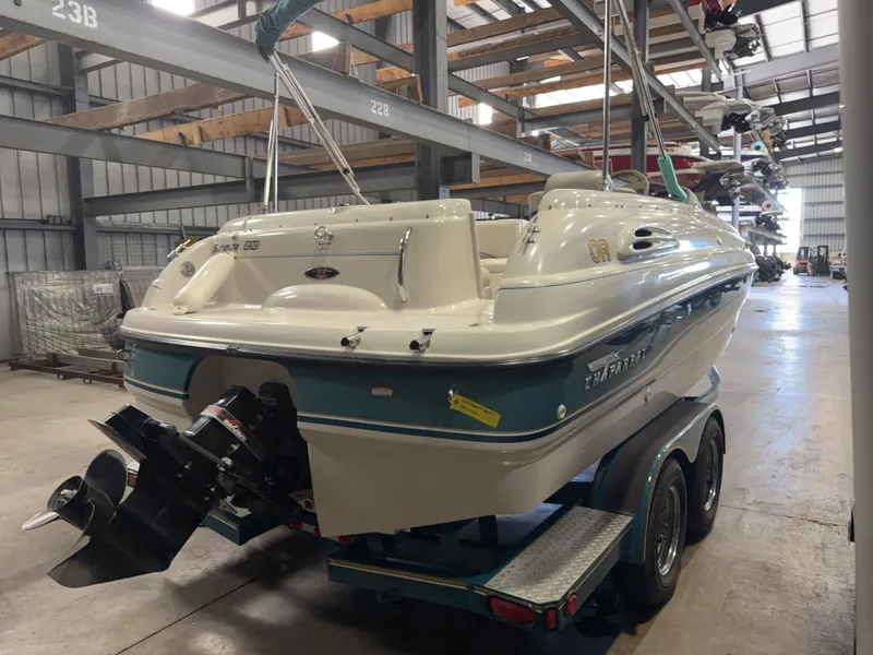 Slide: The Image of A 1996 Chaparral 210 Sunesta on a trailer inside a warehouse. - 5