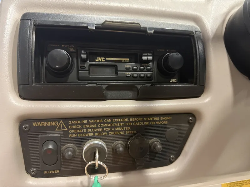 Slide: The Image of The image shows a JVC car stereo in a boat, with a warning about gasoline vapors below. - 25