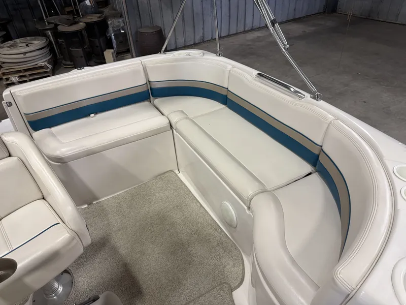 Slide: The Image of The image shows the seating area of a 1996 Chaparral 210 Sunesta boat with white upholstery. - 18
