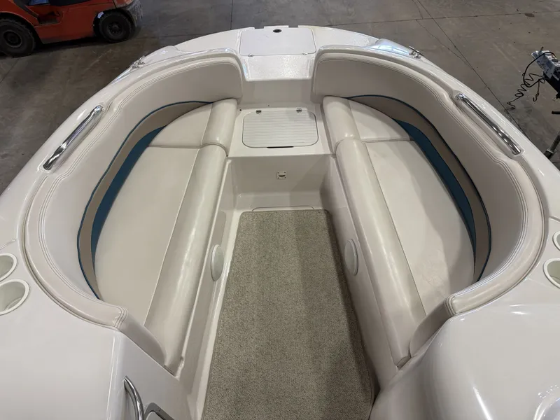 Slide: The Image of The image shows the bow area of a Chaparral 210 Sunesta boat with white upholstery. - 32