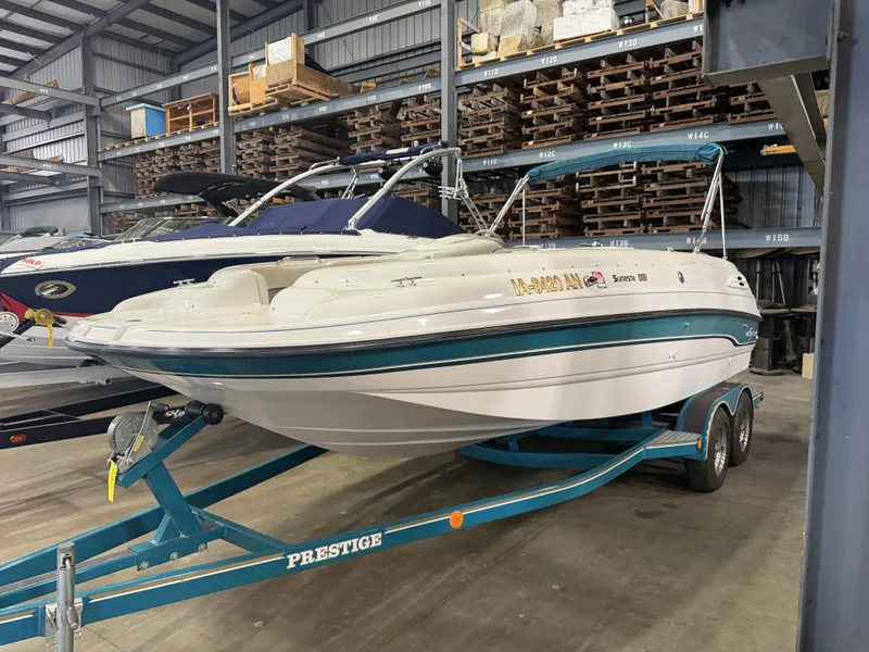 The Image of A 1996 Chaparral 210 Sunesta on a trailer in a warehouse. - 1