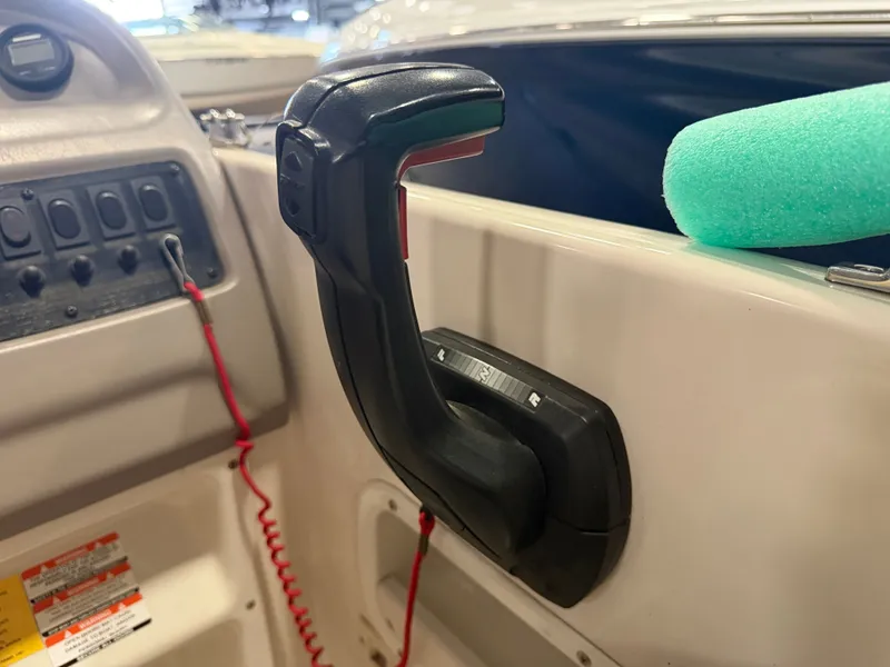 Slide: The Image of Close-up of a throttle lever on a boat, surrounded by controls and a green float. - 28