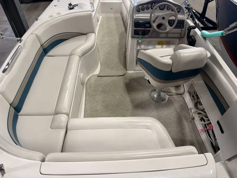 Slide: The Image of Interior view of a 1996 Chaparral 210 Sunesta with beige carpet and white seating. - 17