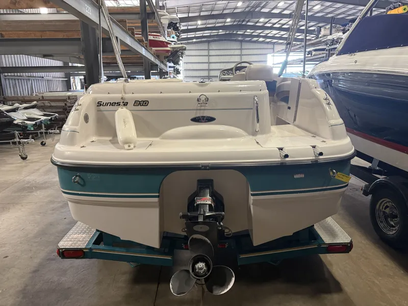 Slide: The Image of Rear view of a Chaparral 210 Sunesta boat in a storage facility. - 38
